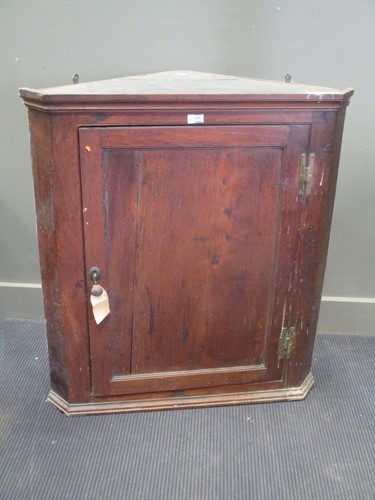 Lot 428 - An 18th century oak splay front hanging corner...
