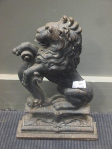 Lot 500 - A cast iron door stop in the form of a rampant...