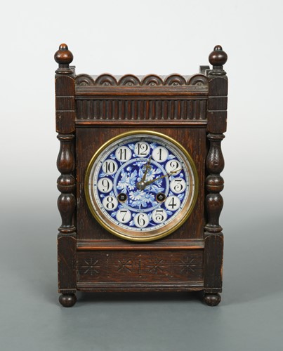 Lot 141 - An Aesthetic Movement oak bracket clock in the manner of Lewis Foreman Day, circa 1880