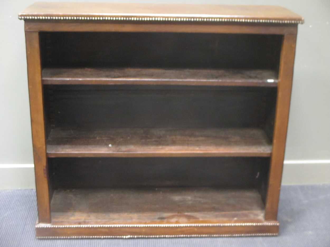 Lot 514 - A leather studded bookcase with adjustable...
