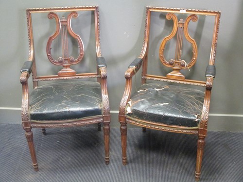 Lot 389 - A pair of leather upholstered lyre back elbow...