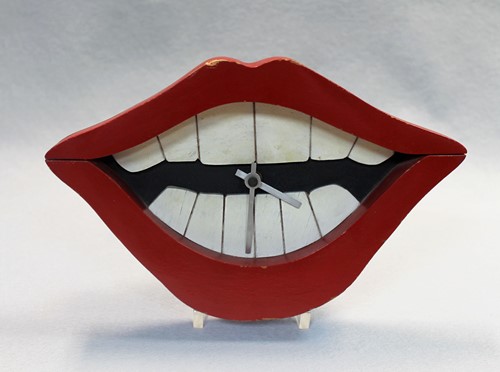 Lot 380 - A painted wood wall clock as the Joker's Smile from Batman