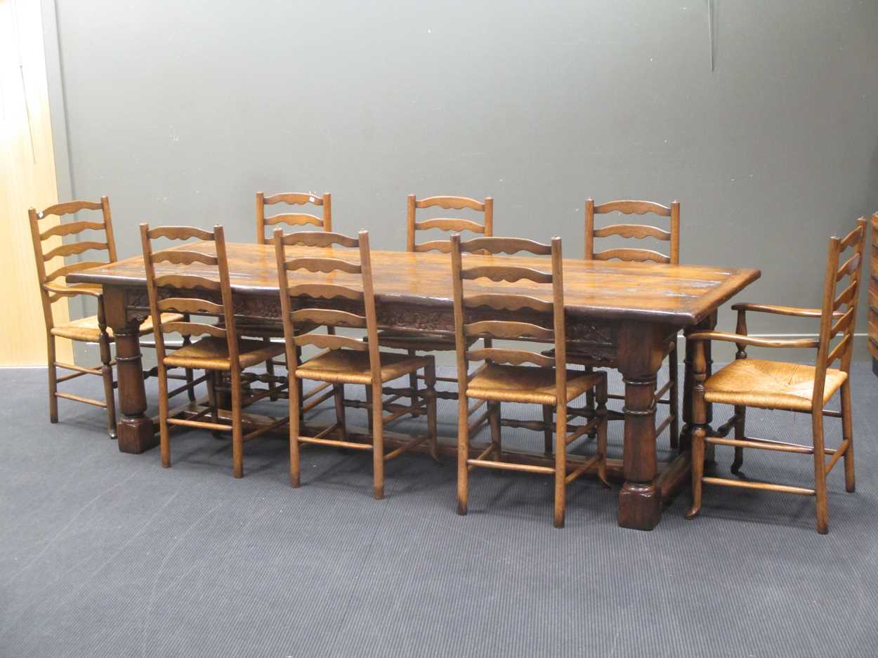 Lot 355 - A reproduction oak refectory table with carved...