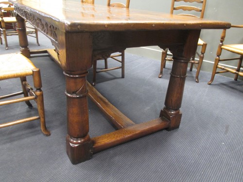 Lot 355 - A reproduction oak refectory table with carved...