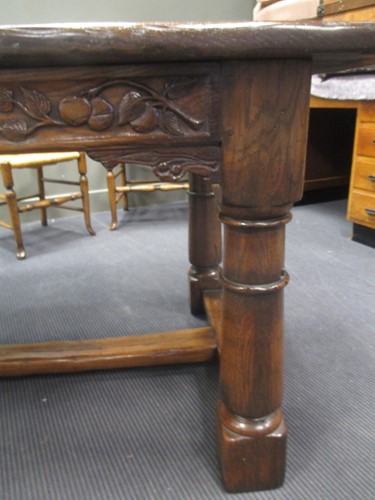 Lot 355 - A reproduction oak refectory table with carved...