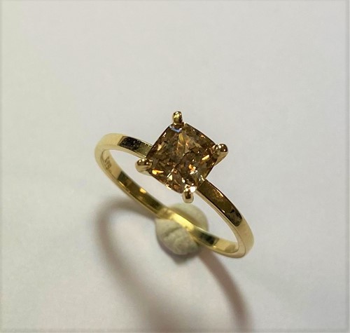 Lot 197 - A single stone ring set with a natural fancy coloured diamond