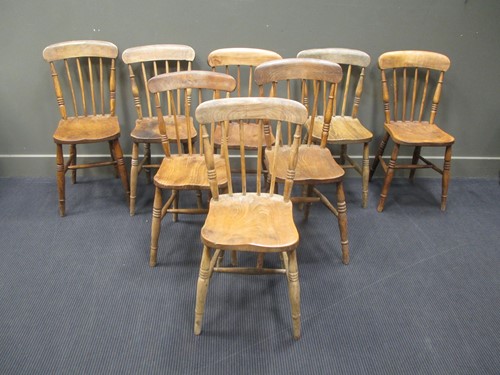 Lot 392 - A set of eight elm seated farmhouse dining chairs
