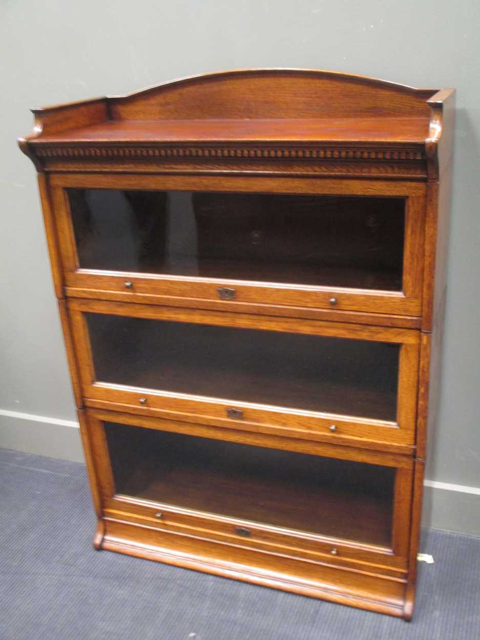 Lot 344 - A "LEBUS" oak three tier stacking bookcase...