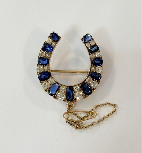 Lot 173 - A late 19th Century sapphire & diamond horseshoe brooch