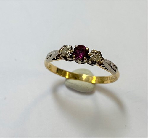 Lot 156 - A three stone ruby and diamond ring