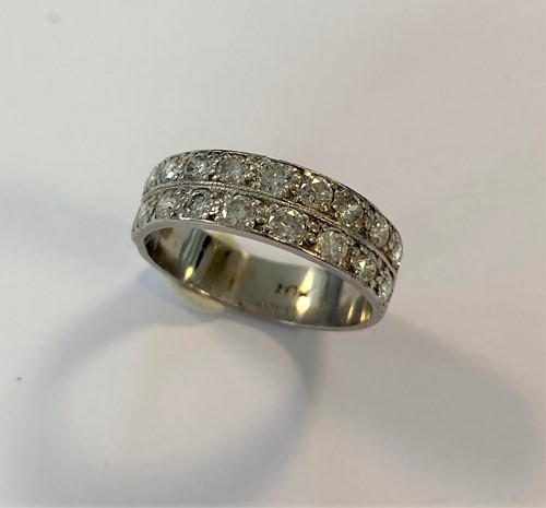 Lot 142 - A double row diamond half hoop ring