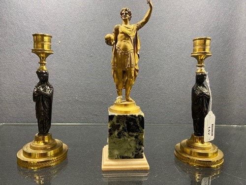Lot 142 - A pair of Regency bronze and gilt bronze figural candlesticks