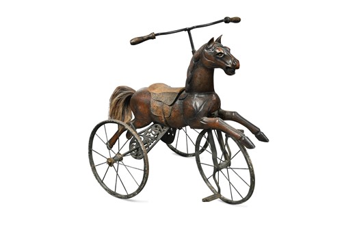 Lot 571 - A carved wooden horse mounted as a tricycle, early 20th century