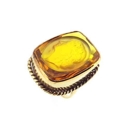 Lot 13 - A dress ring with a carved intaglio citrine