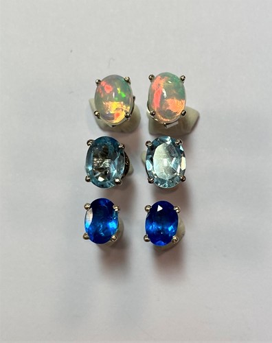 Lot 129 - Three pairs of single stone earstuds - opal, blue topaz and blue apatite