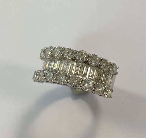 Lot 204 - A modern half hoop ring set with diamonds