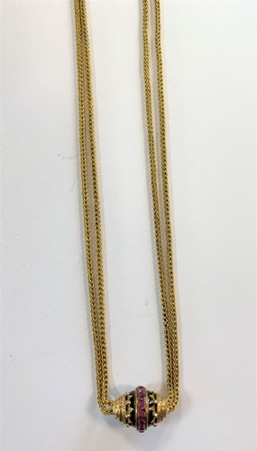 Lot 152 - A long guard chain with ruby and enamel slider