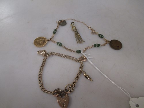 Lot 256 - A 9ct curb style charm bracelet with three...