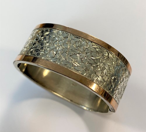 Lot 3 - A bi - colour Victorian silver bangle