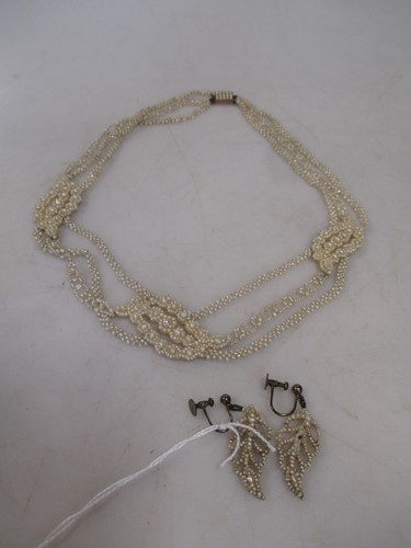 Lot 269 - a three row floral seed pearl necklace with a...