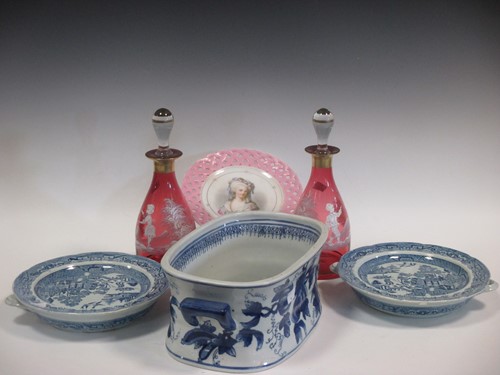 Lot 14 - A pair of cranberry glass carafes painted with...