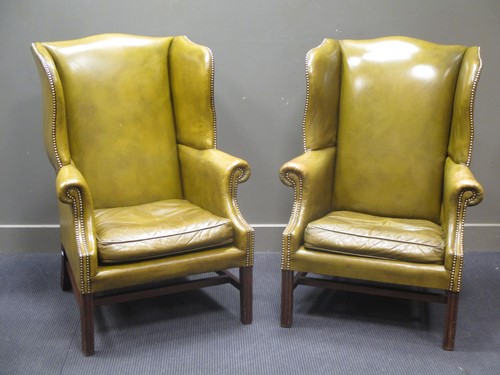 Lot 694 - A pair of George III style green leather...