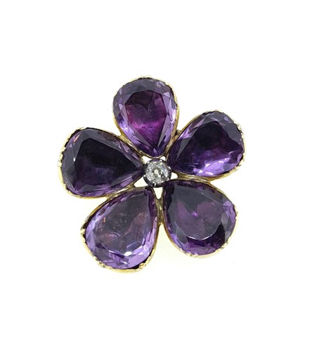 Lot 31 - An amethyst and diamond set flower brooch