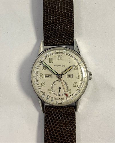 Lot 302 - Movado – A gentleman’s stainless steel triple calendar wristwatch