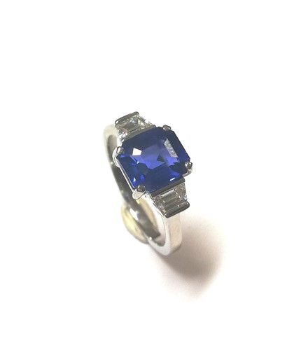 Lot 180 - A modern sapphire and diamond three stone ring
