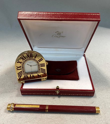 Lot 391 - Cartier - A 'must de Cartier' travelling alarm clock and ballpoint pen