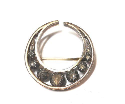 Lot 39 - A Victorian diamond set crescent brooch