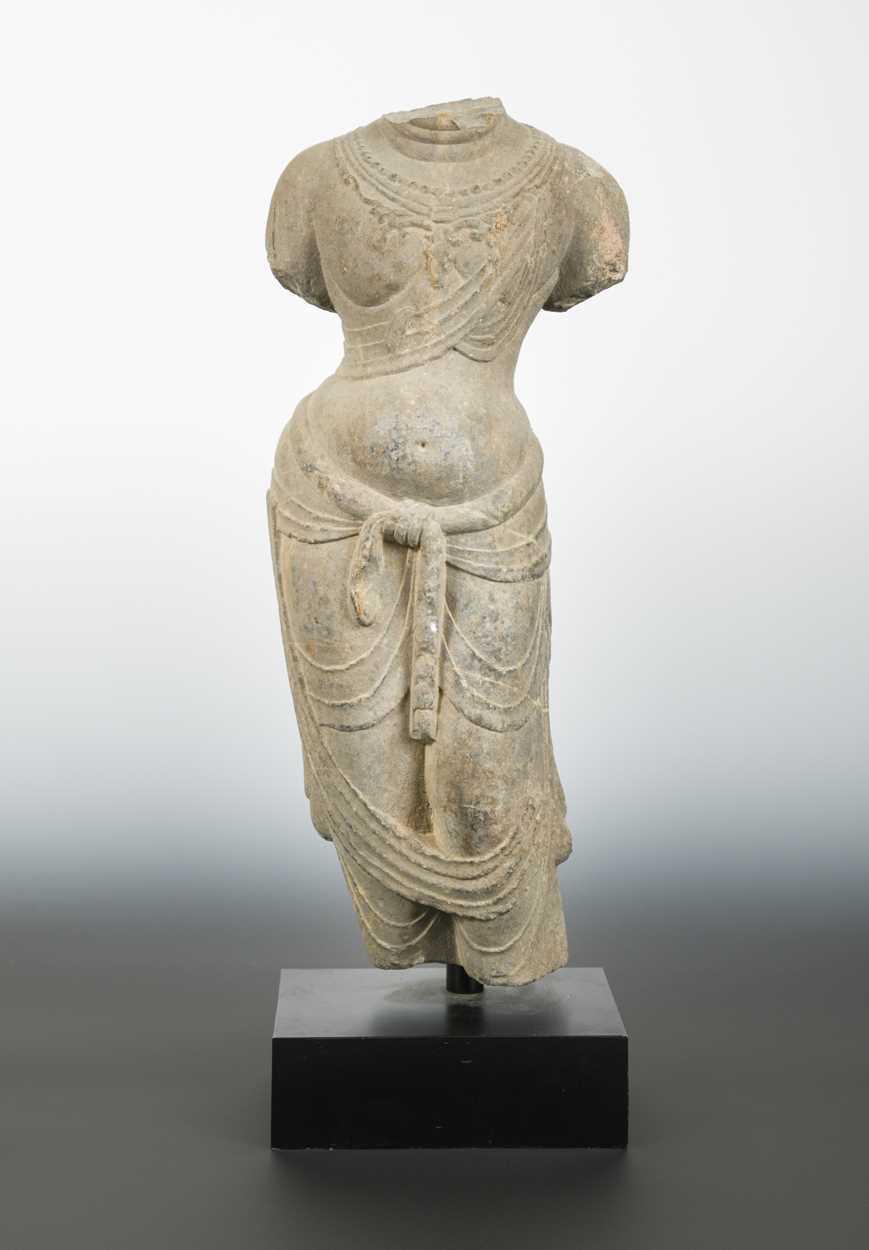 Lot 140 - A Chinese limestone torso of an enrobed