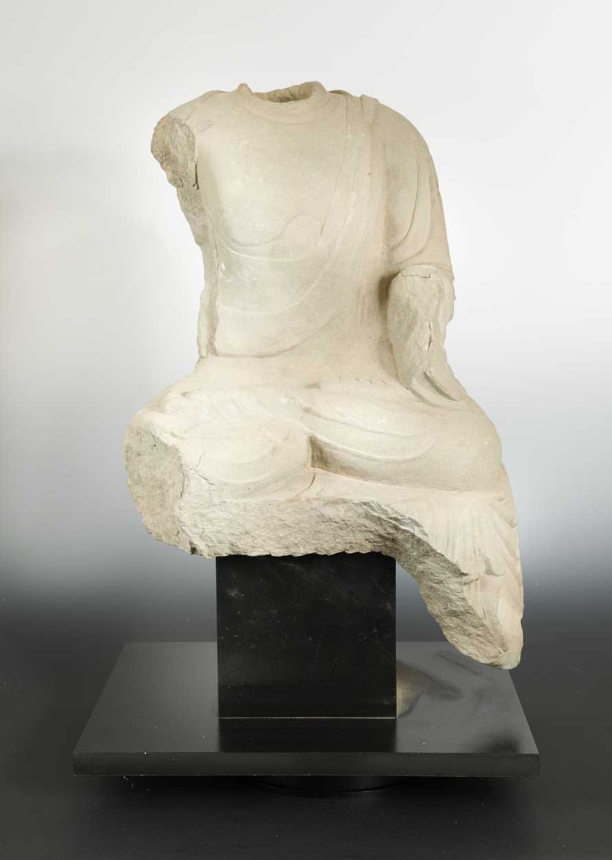 Lot 142 - A Chinese limestone seated Buddha, headless, perhaps Northern Wei Dynasty