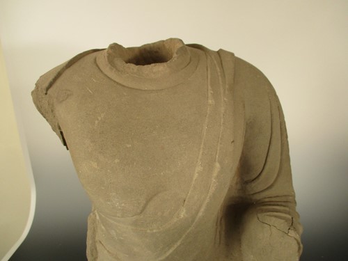 Lot 142 - A Chinese limestone seated Buddha, headless, perhaps Northern Wei Dynasty