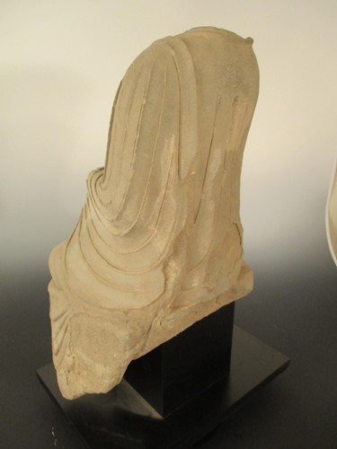 Lot 142 - A Chinese limestone seated Buddha, headless, perhaps Northern Wei Dynasty