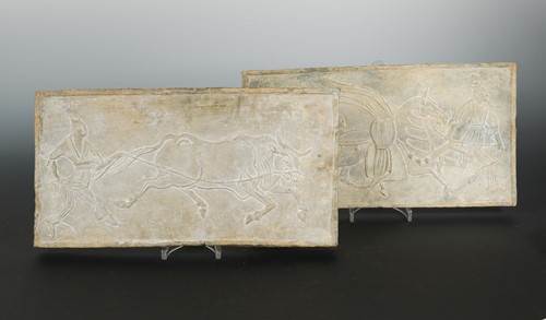Lot 66 - A pair of Chinese grey pottery relief tiles,...