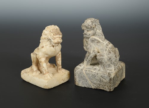 Lot 57 - A Chinese carved white marble seated lion, in...
