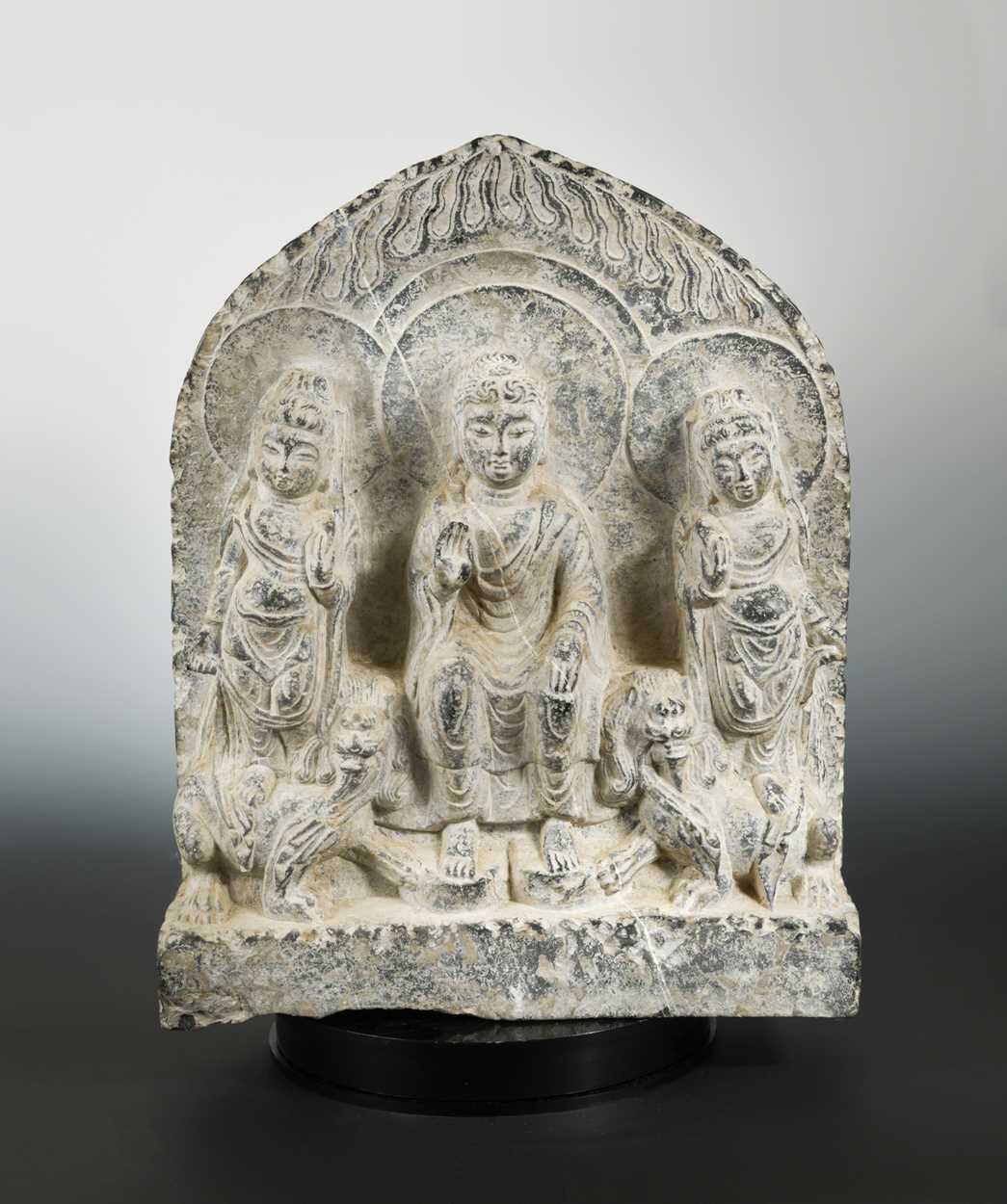 Lot 220 - A Chinese limestone Buddha triad group stele, in Northern Wei Dynasty style