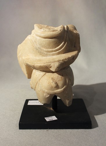 Lot 289 - A white marble fragment of a deity on lotus dais on horseback, in Tang style