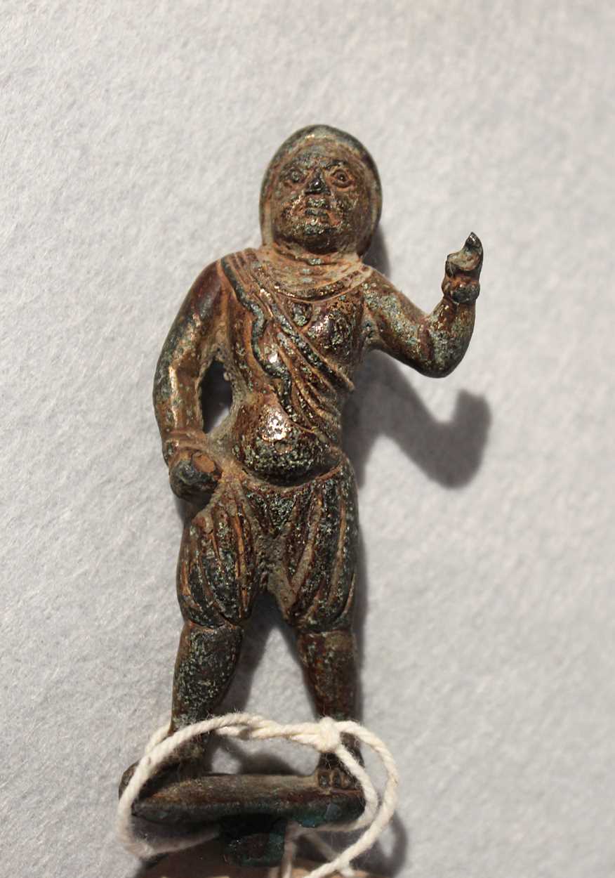 Lot 298 - A Chinese gilt bronze figure of a helmeted man, possibly 10th century