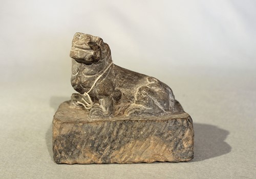 Lot 136 - A Chinese grey stone recumbent fo dog, in Sui...