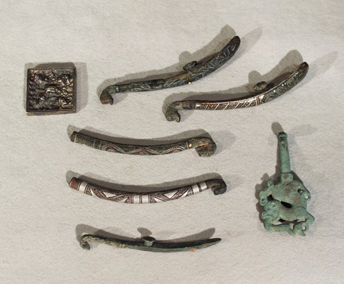 Lot 134 - Six Chinese bronze and inlaid belt hooks in...