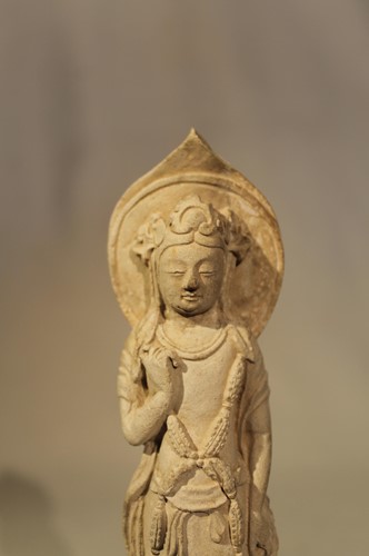 Lot 127 - A Chinese stucco figure of Guanyin standing,...