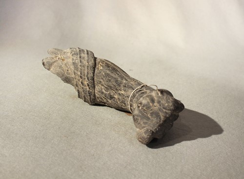 Lot 67 - A Chinese white veined black stone deity arm...