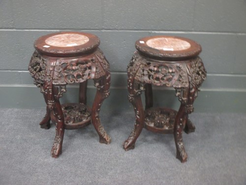 Lot 109 - A pair of Chinese hardwood urn stands 49cm high