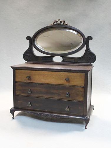 Lot 320 - An early 20th century manicure set contained within a miniature mahogany dressing chest