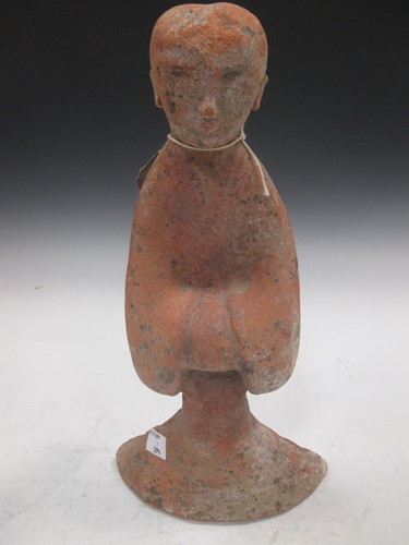 Lot 56 - A Chinese red pottery standing lady attendant,...