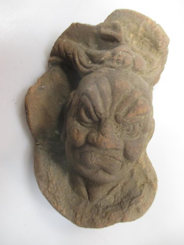 Lot 123 - A Chinese pottery fragmentary face of Lokopala,...