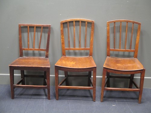 Lot 715 - A pair of elm seated stick back chairs...