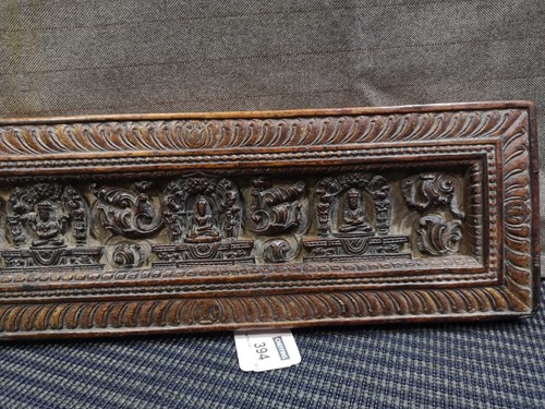 Lot 394 - A Tibetan carved wood manuscript cover, 14th/15th century or later